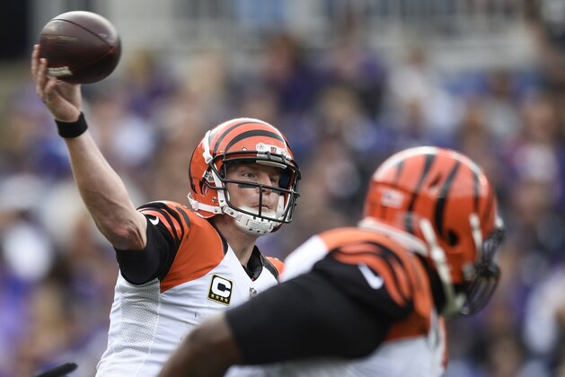 Cincinnati Bengals quarterback Andy Dalton (14) passes the ball during the first half of an NFL football game against the Baltimore Ravens in Baltimore, Sunday, Sept. 27, 2015. (AP Photo/Gail Burton)