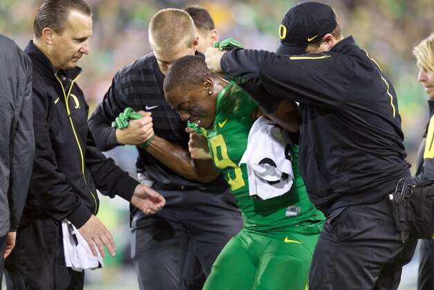 Sep 26, 2015; Eugene, OR, USA; Oregon Ducks wide receiver Byron Marshall (9) is assisted by the training staff following and injury on a punt return against the Utah Utes at Autzen Stadium. Mandatory Credit: Scott Olmos-USA TODAY Sports