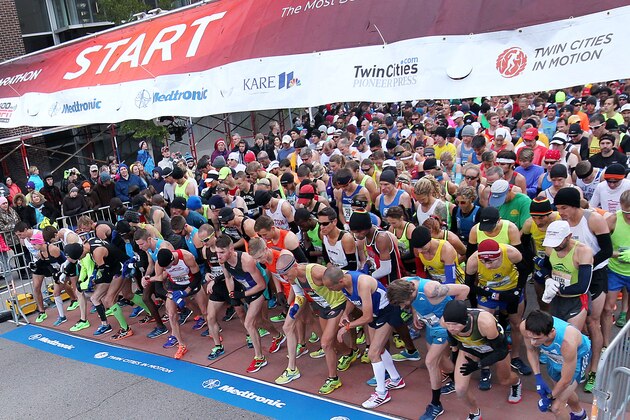 The first wave of runners prepare start in the Twin Cities Marathon on Sunday, Oct. 5, 2014 in Minneapolis.  (AP Photo/Andy Clayton-King)