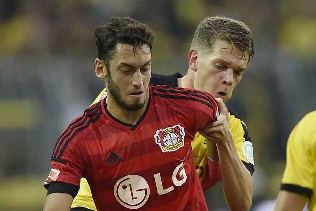 Dortmund's Matthias Ginter, right, and Leverkusen's Hakan Calhanoglu challenge for the ball during the German Bundesliga soccer match between Borussia Dortmund and Bayer Leverkusen in Dortmund, Germany, Sunday, Sept. 20, 2015. (AP Photo/Martin Meissner)