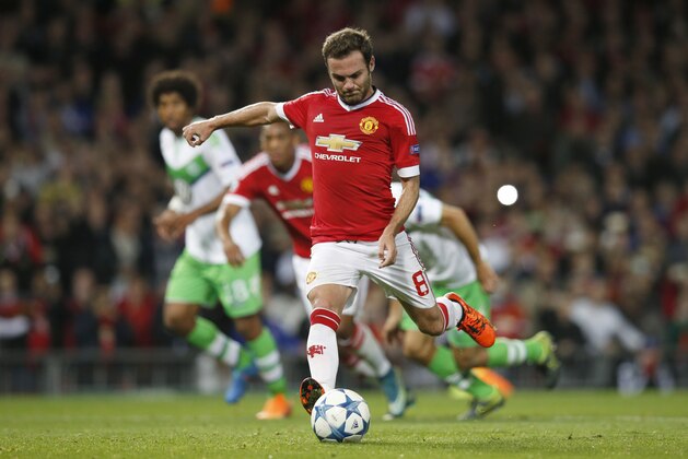 Manchester United's Juan Mata scores a penalty during the Champions League Group B soccer match between Manchester United and VfL Wolfsburg at Old Trafford Stadium in Manchester, England, Wednesday, Sept. 30, 2015. (AP Photo/Jon Super)