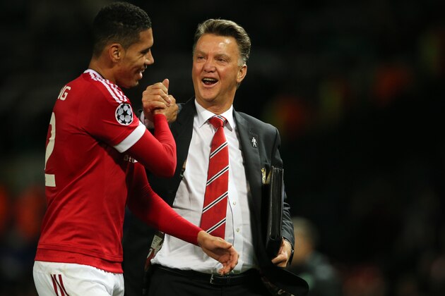 MANCHESTER, ENGLAND - SEPTEMBER 30:  Chris Smalling of Manchester United who scored the winning goal gets congratulated by Louis van Gaal the head coach / manager of Manchester United at the end of the UEFA Champions League match between Manchester United and Wolfsburg at Old Trafford on September 30, 2015 in Manchester, United Kingdom.  (Photo by Matthew Ashton - AMA/Getty Images)