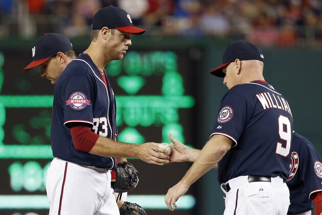 Washington Nationals starting pitcher Doug Fister (33) is relieved by manager Matt Williams (9) during a baseball game against the Milwaukee Brewers at Nationals Park, Friday, Aug. 21, 2015, in Washington. The Brewers won 10-3. (AP Photo/Alex Brandon)