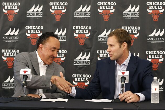 FILE - In this June 2, 2015, file photo, Chicago Bulls general manager Gar Forman, left, shakes hands with Fred Hoiberg after introducing him as the team's new coach during an NBA basketball news conference, in Chicago. The Bulls own the 22nd pick in Thursday's NBA draft. And with a deep pool of guards, drafting a backup for Derrick Rose could be the way they go. (AP Photo/Charles Rex Arbogast, File)