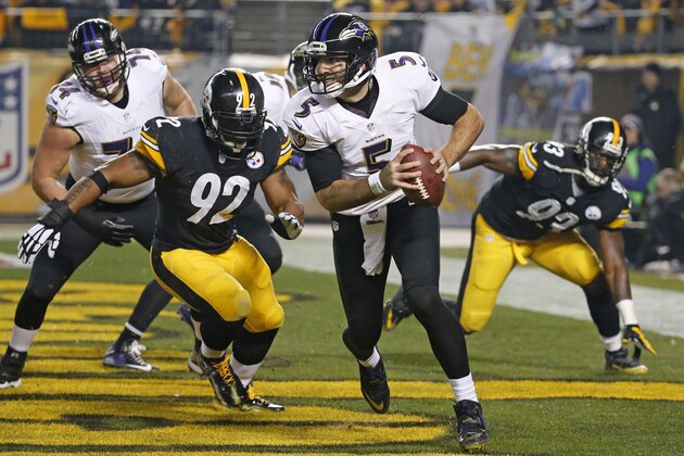 Baltimore Ravens quarterback Joe Flacco (5) is cased out of the pocket by Pittsburgh Steelers outside linebacker James Harrison (92) during the first half of an NFL wildcard playoff football game, Saturday, Jan. 3, 2015, in Pittsburgh. The Ravens won 30-17. (AP Photo/Gene J. Puskar)