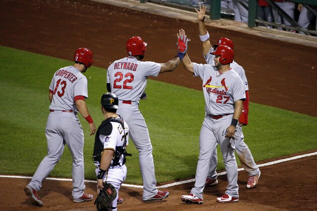 St. Louis Cardinals' Jason Heyward (22) is greeted by teammates Matt Carpenter (13), Jhonny Peralta (27) and Jon Jay after hitting a grand slam off Pittsburgh Pirates pitcher Bobby LaFromboise in the third inning of a baseball game in Pittsburgh, Wednesday, Sept. 30, 2015. (AP Photo/Gene J. Puskar)