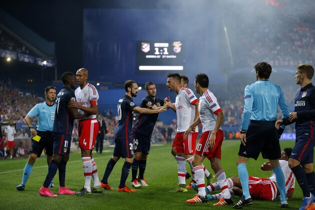 Atletico and Benfica players scuffle each other during the Champions League group C soccer match between Atletico de Madrid and Benfica at the Vicente Calderon stadium in Madrid, Wednesday, Sept. 30, 2015. (AP Photo/Daniel Ochoa de Olza)