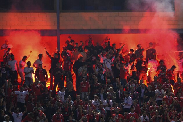 Benfica supporters lit flares during the UEFA Champions League football match Club Atletico de Madrid vs SL Benfica at the Vicente Calderon stadium in Madrid on September 30, 2015.    AFP PHOTO/ PEDRO ARMESTRE        (Photo credit should read PEDRO ARMESTRE/AFP/Getty Images)