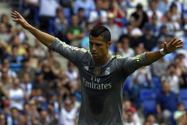 Real Madrid's Portuguese forward Cristiano Ronaldo celebrates after scoring a goal during the Spanish league football match RCD Espanyol vs Real Madrid CF at the Power8 stadium in Cornella de Llobregat on September 12, 2015.   AFP PHOTO/ LLUIS GENE        (Photo credit should read LLUIS GENE/AFP/Getty Images)