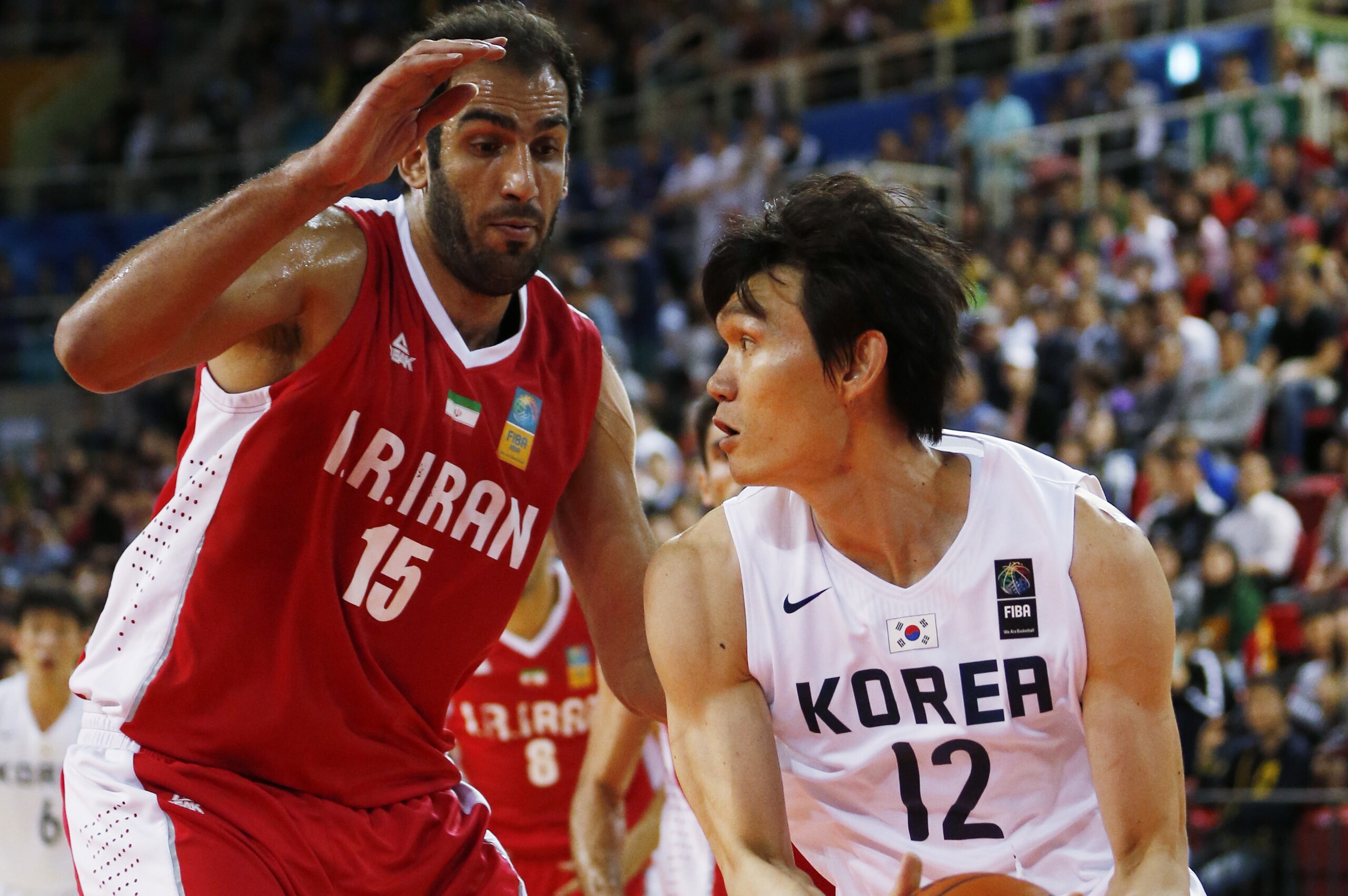 South Korea's Kim Joosung, right drives pass Iran's Hamed Ehadadi during the basketball gold medal match at the 17th Asian Games in Incheon, South Korea, Friday, Oct. 3, 2014.  (AP Photo/Kin Cheung)