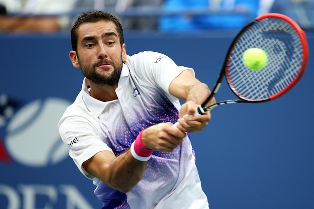 NEW YORK, NY - SEPTEMBER 11:  Marin Cilic of Croatia returns a shot to Novak Djokovic of Serbia during their Men's Singles Semifinals match on Day Twelve of the 2015 US Open at the USTA Billie Jean King National Tennis Center on September 11, 2015 in the Flushing neighborhood of the Queens borough of New York City.  (Photo by Matthew Stockman/Getty Images)