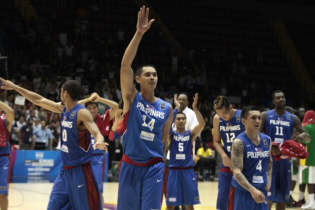 Japeth Aguilar of the Philippines, center, waves with teammates after winning the Group B Basketball World Cup match against Senegal in Seville, Spain, Thursday, Sept. 4, 2014. The 2014 Basketball World Cup competition will take place in various cities in Spain from Aug. 30 through to Sept. 14. (AP Photo/Miguel Angel Morenatti)