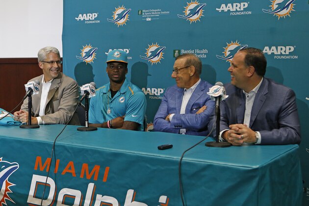 DAVIE, FL - MAY 1: DeVante Parker talks to the media as (L - R) General Manager Dennis Hickey, Chairman of the Board/Managing General Partner Stephen M. Ross, and Executive Vice President of Football Operations Mike Tannenbaum of the Miami Dolphins watch on May 1, 2015 at the Miami Dolphins training facility in Davie, Florida. Parker was the Dolphins first round draft choice at the 14th pick in the NFL Draft. Parker played four seasons with the Louisville Cardinals. (Photo by Joel Auerbach/Getty Images)