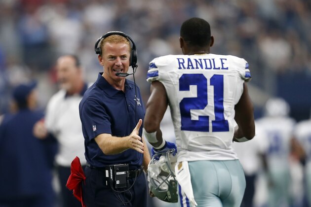 Dallas Cowboys head coach Jason Garrett greets running back Joseph Randle (21) after Randle scored a touchdown in the first half of an NFL football game against the Atlanta Falcons on Sunday, Sept. 27, 2015, in Arlington, Texas. (AP Photo/Brandon Wade)