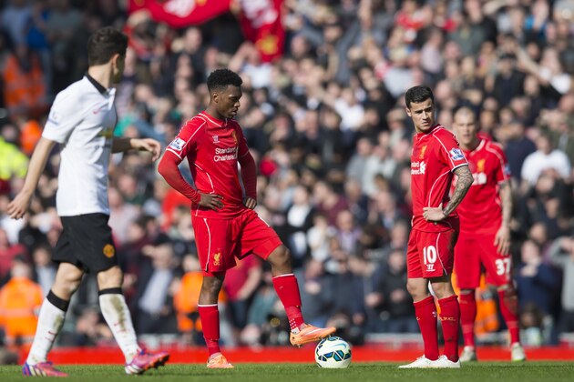 Liverpool's Daniel Sturridge, centre left, and Philippe Coutinho, centre right, wait for play to restart after Manchester United's second goal during the English Premier League soccer match between Liverpool and Manchester United at Anfield Stadium, Liverpool, England, Sunday, March 22, 2015. (AP Photo/Jon Super)