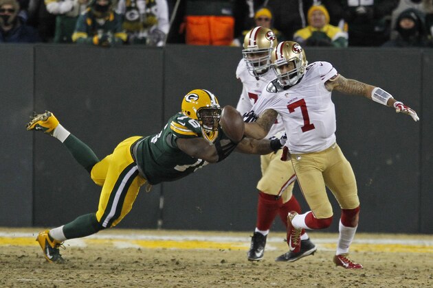 San Francisco 49ers quarterback Colin Kaepernick tries to scramble past Green Bay Packers defensive end Mike Daniels during an NFL wild-card playoff football game Sunday, Jan. 5, 2014, in Green Bay, Wis. (AP Photo/Matt Ludtke)