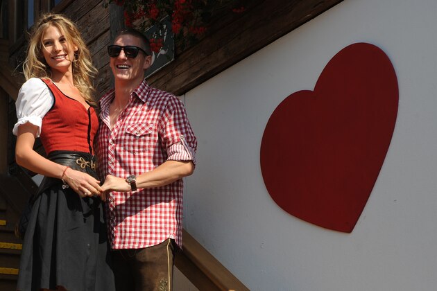 Bayern Munich's midfielder Bastian Schweinsteiger and his girlfriend Sarah Brandner arrive dressed in traditional Bavarian clothes for the visit to the Oktoberfest in the southern German city of Munich, October 2, 2011. Team members of FC Bayern Munich attended the Oktoberfest with their partners on this day. AFP PHOTO/CHRISTOF STACHE (Photo credit should read CHRISTOF STACHE/AFP/Getty Images)