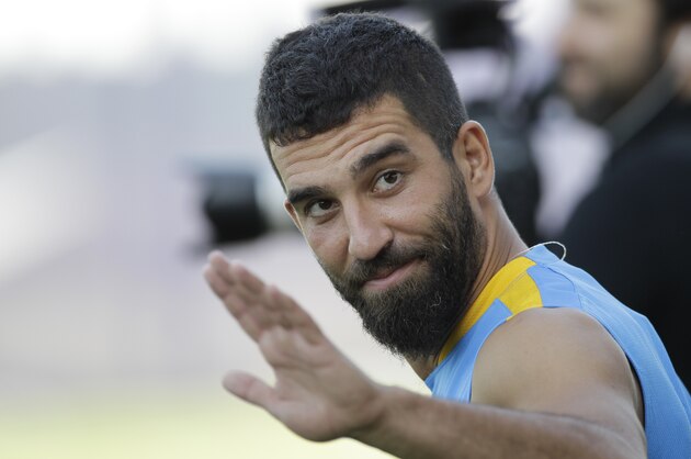 FC Barcelona's Arda Turan gestures during the first training session of the 2015-2016 football season at the Sports Center FC Barcelona Joan Gamper in the San Joan Despi, Spain, Monday, July 13, 2015. (AP Photo/Manu Fernandez)