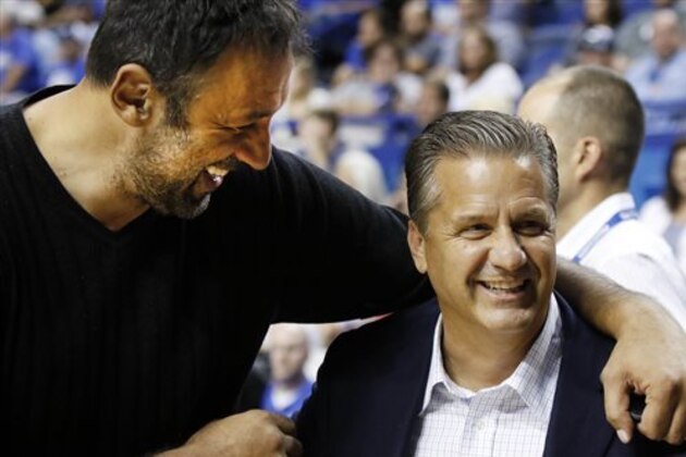 Kentucky head coach John Calipari, right, laughs with Sacramento Kings general manager Vlade Divac during a basketball fund raiser between former Kentucky and North Carolina players, Sunday, Sep. 13, 2015, in Lexington, Ky. The Kentucky squad won 122-115. (AP Photo/James Crisp)