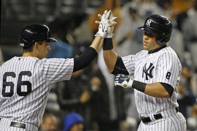 New York Yankees on-deck batter  John Ryan Murphy greets Yankees Carlos Beltran after Beltran hit a second-inning, solo home run off Boston Red Sox starting pitcher Rich Hill in a baseball game in New York, Thursday, Oct. 1, 2015.   (AP Photo/Kathy Willens)