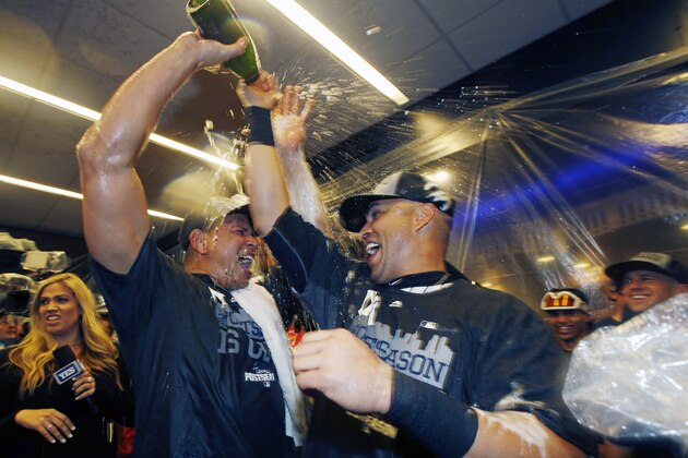New York Yankees designated hitter Alex Rodriguez, left, celebrates with New York Yankees right fielder Carlos Beltran in the locker room after the Yankees clinched a wild car berth in the playoffs after defeating the Boston Red Sox 4-1 in a baseball game in New York, Thursday, Oct. 1, 2015.   (AP Photo/Kathy Willens)