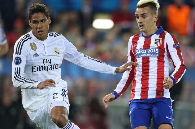 MADRID, SPAIN - APRIL 14: Raphael Varane of Real Madrid and Antoine Griezmann of Atletico Madrid in action during the UEFA Champions League Quarter Final First Leg match between Atletico Madrid and Real Madrid at Estadio Vicente Calderon stadium on April 14, 2015 in Madrid, Spain. (Photo by Jean Catuffe/Getty Images)