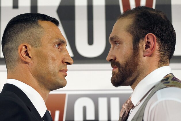 World Heavyweight boxing champion  Wladimir Klitschko, left, and British heavyweight Tyson Fury stare at each other  during a press conference in London, Wednesday, Sept. 23, 2015.  Klitschko will fight Fury in a heavyweight title bout on Oct. 24,  in Duesseldorf, Germany.(AP Photo/Frank Augstein)