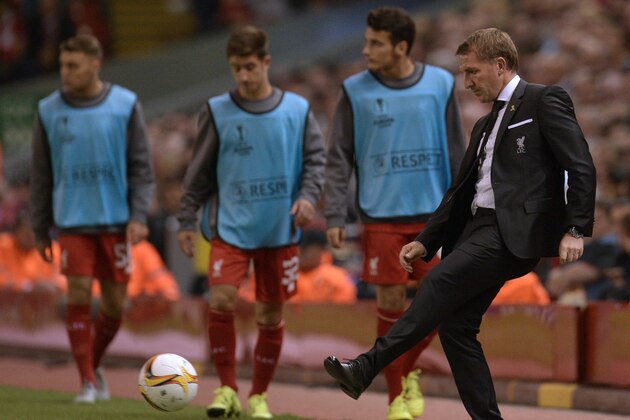 Liverpool's Northern Irish manager Brendan Rodgers (R) passes the ball back into play during the UEFA Europa League group B football match between Liverpool and FC Sion at Anfield in Liverpool, north west England on October 1, 2015. AFP PHOTO / OLI SCARFF        (Photo credit should read OLI SCARFF/AFP/Getty Images)