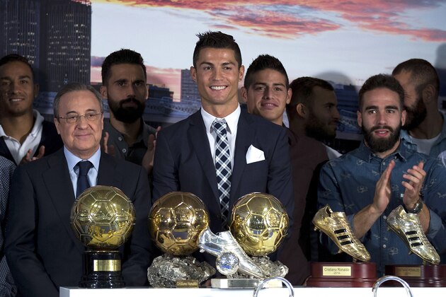 MADRID, SPAIN - OCTOBER 02:  Cristiano Ronaldo (5thR) poses for a picture with his trophy as all-time top scorer of Real Madrid CF, all trophys won as Real Madrid players, president Florentino Perez (2ndL) and all his teammates as James Rodriguez (4thR), Jese Rodriguez (3dR), Daniel Carvajal (2ndR), Karim Benzema (R) and  Alvaro Arbeloa (3dL) at Honour box-seat of Santiago Bernabeu  Stadium on October 2, 2015 in Madrid, Spain. Portuguese palyer Cristiano Ronaldo overtook on his last UEFA Champions League match against Malmo FF Raul's record as Real Madrid all-time top scorer.  (Photo by Gonzalo Arroyo Moreno/Getty Images)
