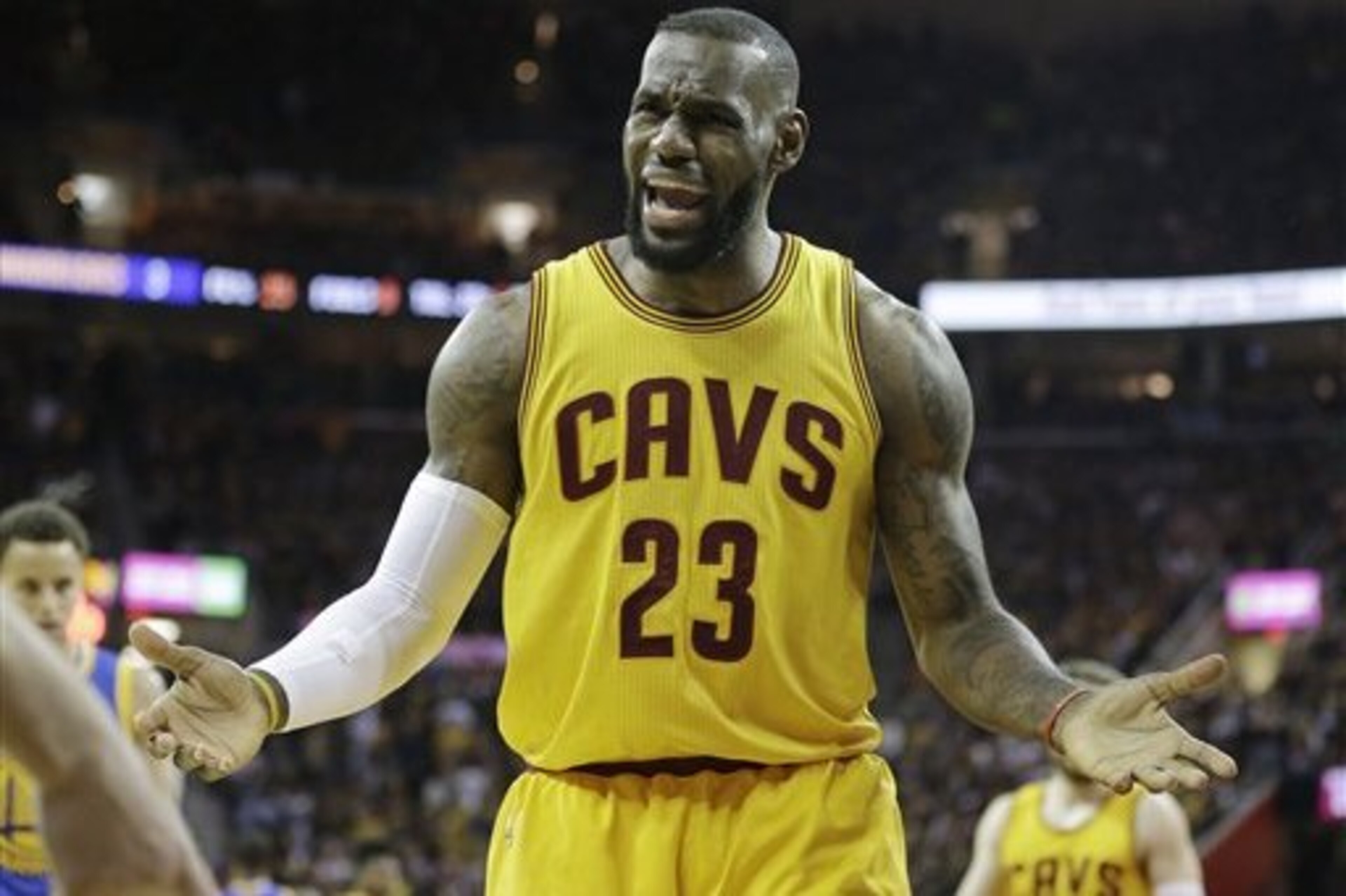 Cleveland Cavaliers forward LeBron James (23) questions a call during the first half of Game 4 of basketball's NBA Finals against the Golden State Warriors in Cleveland, Thursday, June 11, 2015. (AP Photo/Tony Dejak)