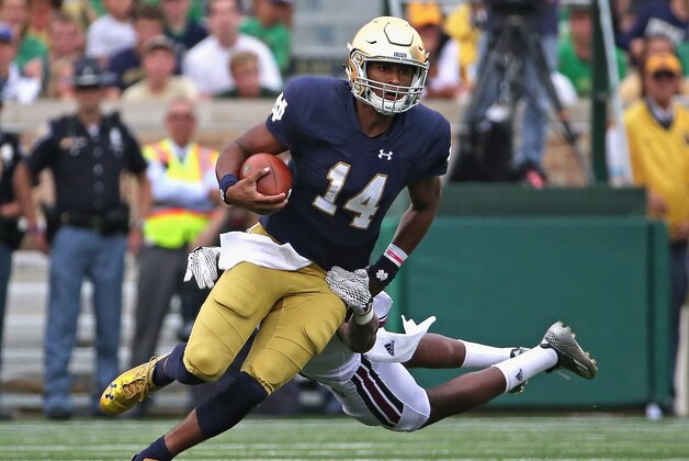 SOUTH BEND, IN - SEPTEMBER 26: DeShone Kizer #14 of the Notre Dame Fighting Irish breaks away from Kassan Messiah #3 of the Massachusetts Minutemen at Notre Dame Stadium on September 26, 2015 in South Bend, Indiana. (Photo by Jonathan Daniel/Getty Images)