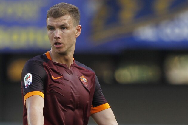 Roma's Edin Dzeko opens his arms during a Serie A soccer match against Hellas Verona at the Bentegodi stadium in Verona, Italy, Saturday, Aug. 22, 2015. (AP Photo/Felice Calabro')