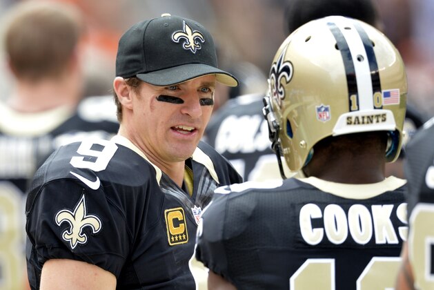 New Orleans Saints quarterback Drew Brees, left, talks to wide receiver Brandin Cooks in the second quarter of an NFL football game against the Cleveland Browns Sunday, Sept. 14, 2014, in Cleveland. Cleveland won 26-24. (AP Photo/David Richard)