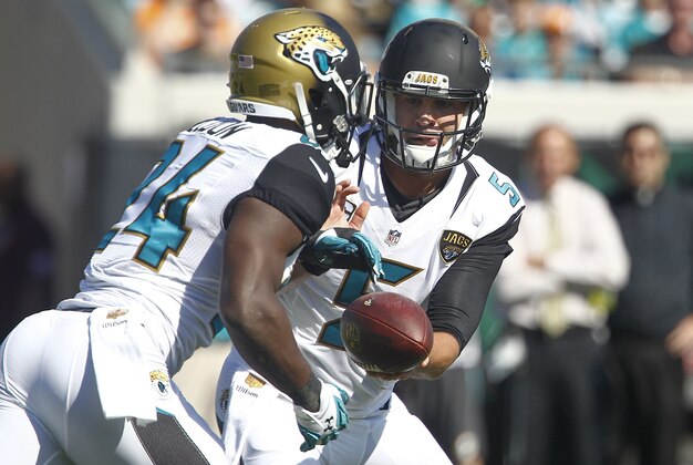 Sep 20, 2015; Jacksonville, FL, USA; Jacksonville Jaguars quarterback Blake Bortles (5) hands off to running back T.J. Yeldon (24) during the first quarter of an NFL Football game against the Miami Dolphins at EverBank Field. Mandatory Credit: Reinhold Matay-USA TODAY Sports