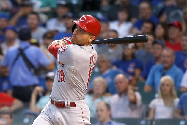 Cincinnati Reds' Joey Votto hits a home run off Chicago Cubs starting pitcher Dan Haren during the first inning of a baseball game Tuesday, Sept. 1, 2015, in Chicago. (AP Photo/Charles Rex Arbogast)