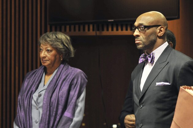 Former NFL football star, Irving Fryar, right, and his mother Allene McGhee appear before Judge James W. Palmer in Burlington County Superior Court in Mount Holly, N.J., Tuesday, Jan. 21, 2014, as they pleaded not guilty to charges that they conspired to steal more than $690,000 through a mortgage scam. State prosecutors allege Fryar's 80-year-old mother, Allene McGhee, of Willingboro, N.J., submitted false information to obtain five loans on her home within a six-day period. (AP Photo/Burlington County Times, Dennis McDonald, Pool)