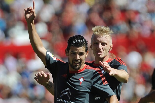 Celta Vigo's forward Nolito (L) celebrates a goal with Celta Vigo's Danish defender Daniel Wass (R) during the Spanish league football match Sevilla FC vs Celta de Vigo at the Ramon Sanchez Pizjuan stadium in Sevilla on September 20, 2015.    AFP PHOTO/ CRISTINA QUICLER        (Photo credit should read CRISTINA QUICLER/AFP/Getty Images)