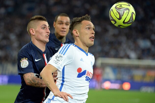 Marseille's Argentinian midfielder Lucas Ocampos (R) vies for the ball with Paris Saint-Germain's Italian midfielder Marco Verratti (L) during the French L1 football match between Marseille (OM) and Paris (PSG) on April 5, 2015 at the Velodrome stadium in Marseille, southern France. AFP PHOTO / BORIS HORVAT        (Photo credit should read BORIS HORVAT/AFP/Getty Images)