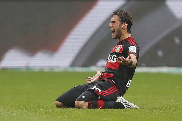 Leverkusen's Hakan Calhanoglu from Turkey celebrates after scoring the opening goal during the German first division Bundesliga soccer match between Bayer Leverkusen and TSG Hoffenheim in Leverkusen, Germany, Saturday, May 16, 2015. (AP Photo/Frank Augstein)