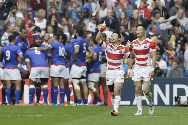 Japan's Akihito Yamada, right, celebrates scoring a try during the Rugby World Cup Pool B match between Samoa and Japan at the stadium:mk, Milton Keynes, England, Saturday, Oct. 3, 2015. (AP Photo/Tim Ireland)