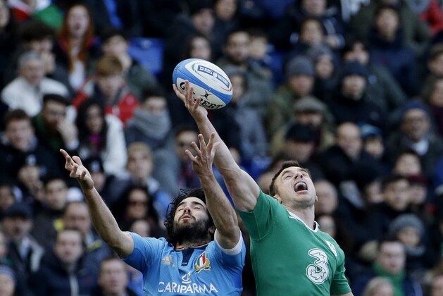 Italy's Luke McLean, left, and Ireland's Robbie Henshaw reach out for the ball during the Six Nations Rugby Union match between Italy and Ireland at Rome's Olympic stadium, Saturday, Feb. 7, 2015. (AP Photo/Gregorio Borgia)