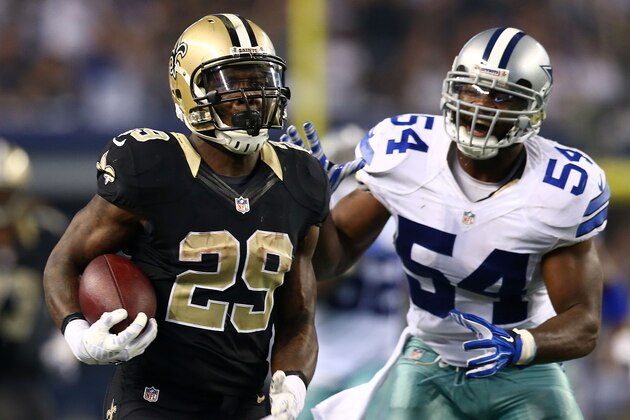 ARLINGTON, TX - SEPTEMBER 28:  Khiry Robinson #29 of the New Orleans Saints runs with the ball as Bruce Carter #54 of the Dallas Cowboys pursues in the second half at AT&T Stadium on September 28, 2014 in Arlington, Texas.  (Photo by Ronald Martinez/Getty Images)
