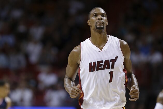 Miami Heat center Chris Bosh (1) runs down the court in the first half of an NBA basketball game against the Atlanta Hawks, Wednesday, Dec. 3,  2014, in Miami. (AP Photo/Lynne Sladky)