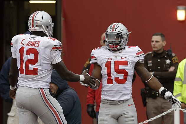 Ohio State's Ezekiel Elliott (15) celebrates with Cardale Jones (12) after Elliott ran 55 yards for a touchdown during the second half of an NCAA college football game  against Indiana, Saturday, Oct. 3, 2015 in Bloomington, Ind. (AP Photo/Darron Cummings)