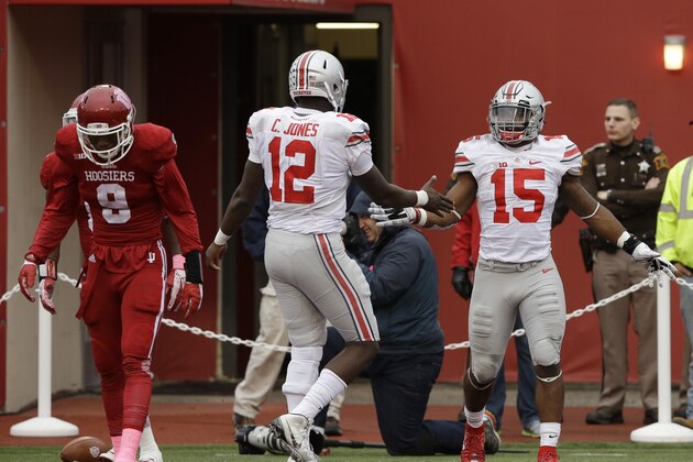 Ohio State's Ezekiel Elliott (15) celebrates with Cardale Jones (12) after Elliott ran 55 yards for a touchdown during the second half of an NCAA college football game against Indiana, Saturday, Oct. 3, 2015 in Bloomington, Ind. Indiana's Jonathan Crawford (9) is at left. (AP Photo/Darron Cummings)