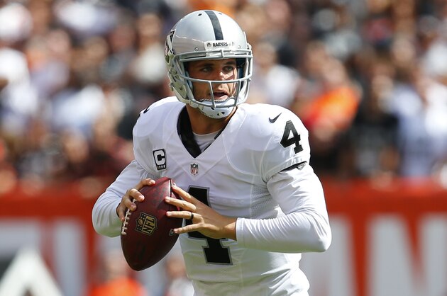 Oakland Raiders quarterback Derek Carr (4) looks to pass against the Cleveland Browns during an NFL football game in Cleveland, Sunday, Sept. 27, 2015. (Jeff Haynes/AP Images for Panini)