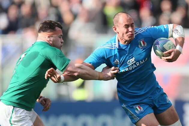 Italy's Sergio Parisse, is tackled by Ireland's Cian Healy, during a Six Nations rugby match between Italy and Ireland, at the Rome Olympic stadium, Saturday, March 16, 2013. (AP Photo/Paolo Giovannini)