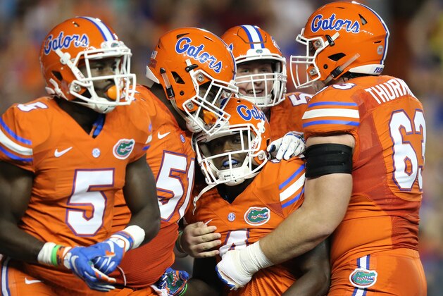 Florida wide receiver Brandon Powell (4), center, is congratulated by teammates after scoring a 77-yard receiving touchdown during the first half of an NCAA college football game against Mississippi Saturday, Oct. 3, 2015, in Gainesville, Fla. (AP Photo/Gary McCullough)
