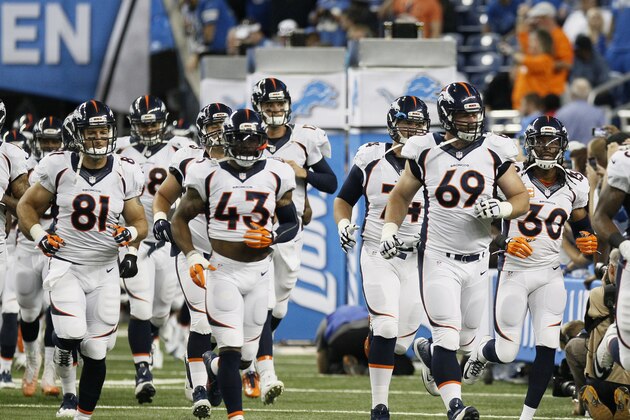 Denver Broncos' Owen Daniels (81) runs on to the field with teammates T.J. Ward (43), Evan Mathis (69), David Bruton (30) before the first quarter of an NFL football game against the Detroit Lions, Sunday, Sept. 27, 2015, in Detroit. (AP Photo/Duane Burleson)