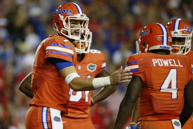 Oct 3, 2015; Gainesville, FL, USA; Florida Gators quarterback Will Grier (7) talks with wide receiver Brandon Powell (4) and teammates during the first half against the Mississippi Rebels at Ben Hill Griffin Stadium. Mandatory Credit: Kim Klement-USA TODAY Sports